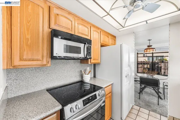a kitchen with stainless steel appliances granite countertop a sink a stove and a microwave