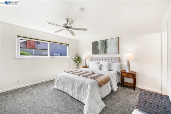 a bathroom with a granite countertop sink mirror vanity and toilet