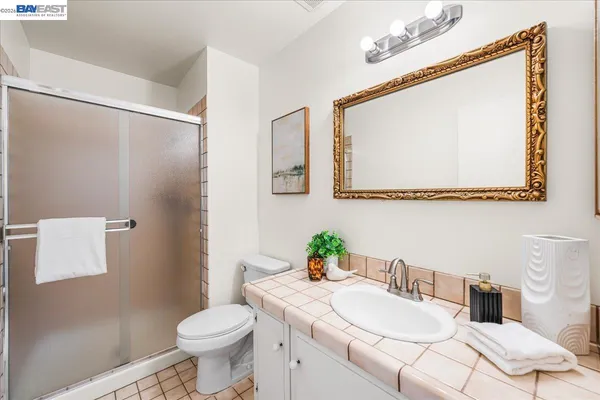 a bathroom with a sink a mirror a toilet and a bathtub