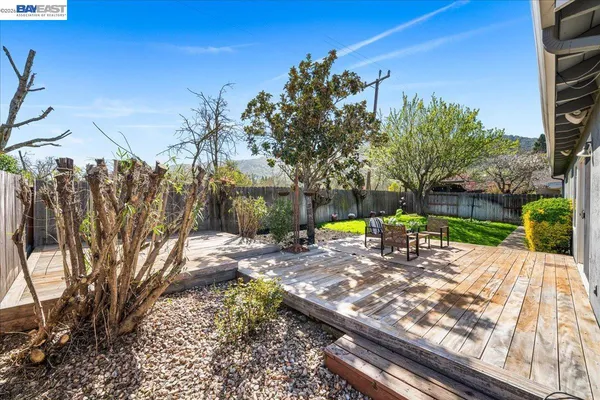 a view of a house with garden and sitting area
