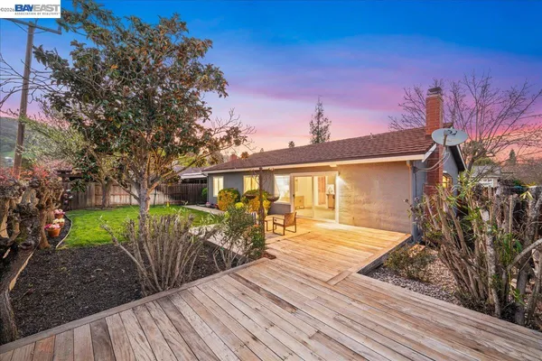a view of a brick house with a yard
