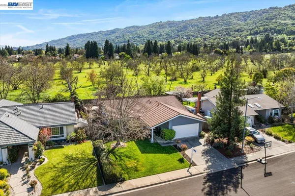 a front view of house with yard and green space