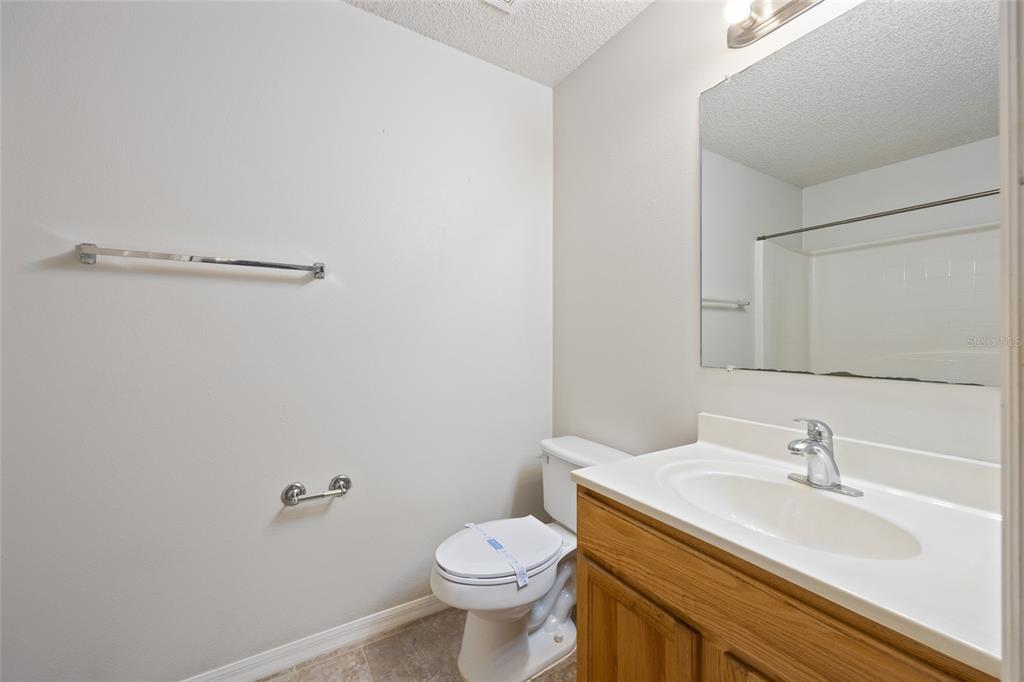 1009 Stratton Avenue Spring Hill, FL 34609 - Photo 13 of 29 a bathroom with a sink vanity mirror and toilet