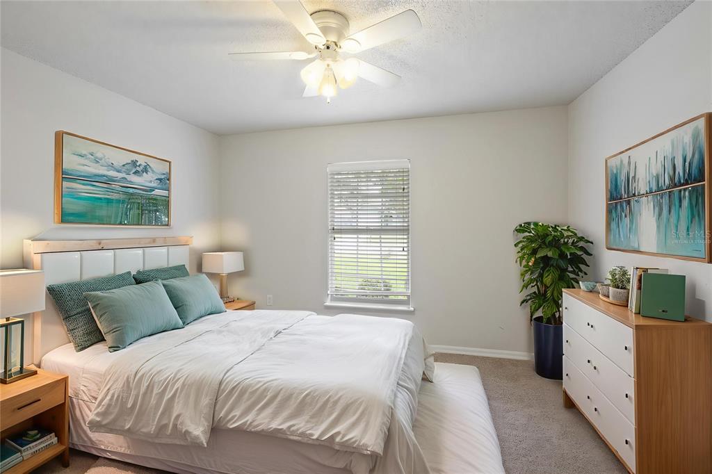 1009 Stratton Avenue Spring Hill, FL 34609 - Photo 15 of 29 a bedroom with a bed and a potted plant