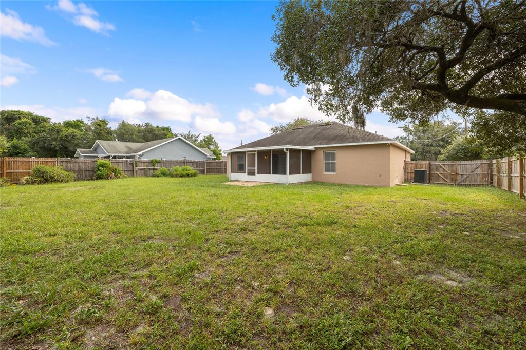 1009 Stratton Avenue Spring Hill, FL 34609 - Photo 21 of 29 a view of a house with a yard and sitting area