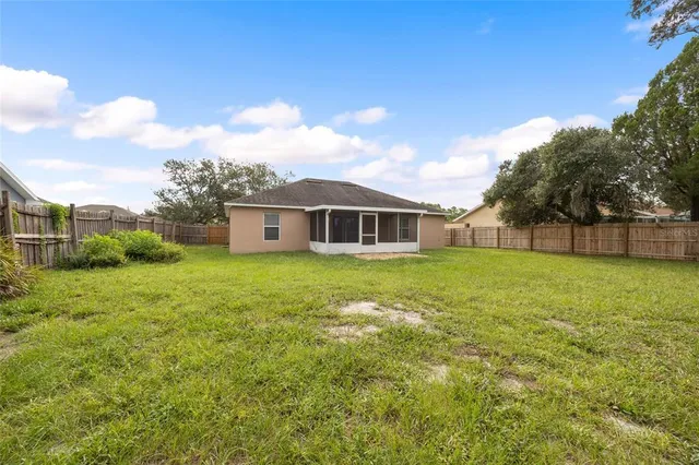 a view of a house with a backyard