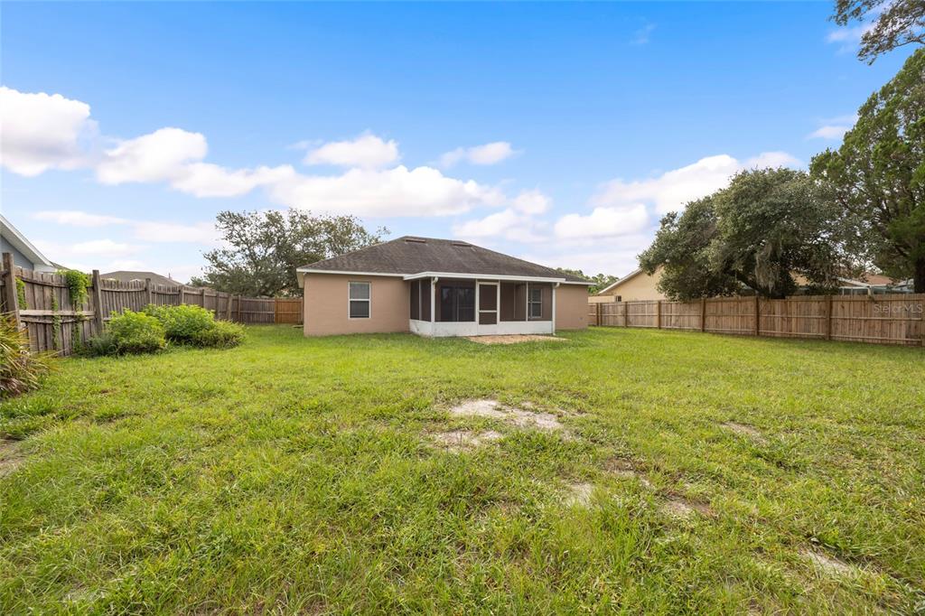 1009 Stratton Avenue Spring Hill, FL 34609 - Photo 22 of 29 a view of a house with a backyard