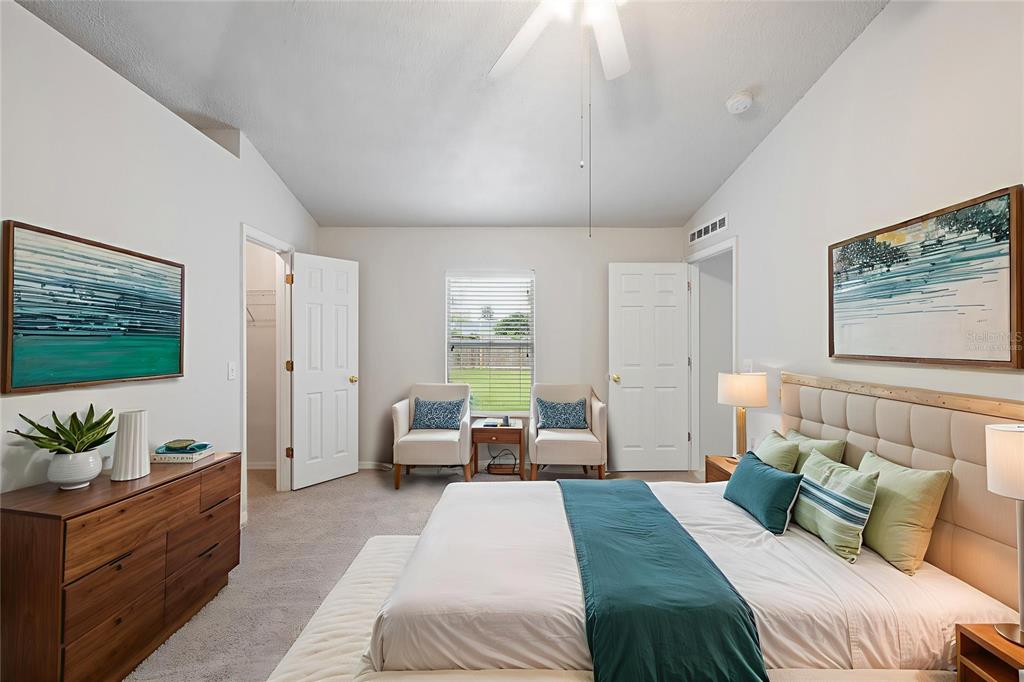 1009 Stratton Avenue Spring Hill, FL 34609 - Photo 8 of 29 a bedroom with a large bed and a couch