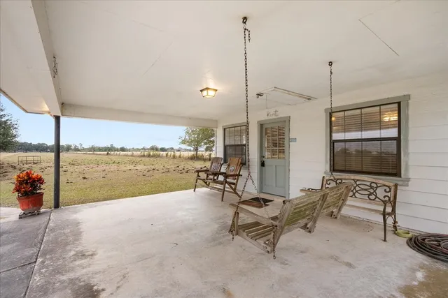 a living room with furniture and a floor to ceiling window