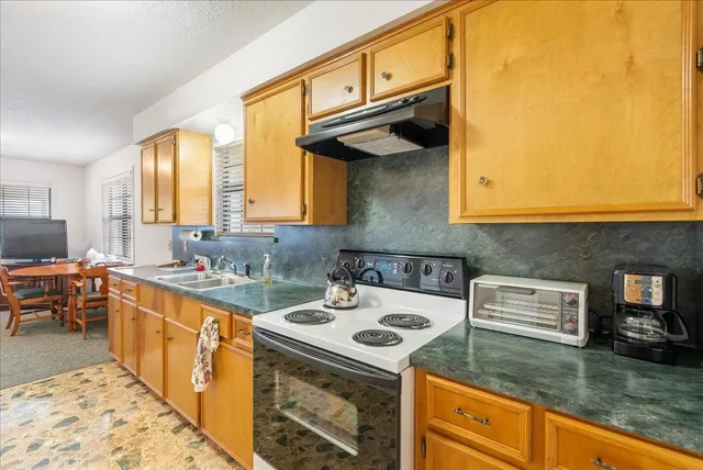 a kitchen with a stove and a sink