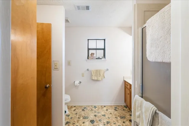 a bathroom with a shower and a sink