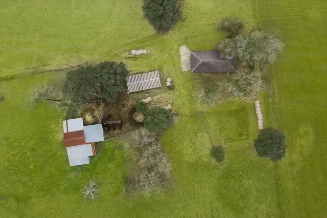 an aerial view of a house with a yard
