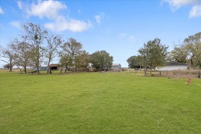 an aerial view of ocean with residential houses with outdoor space