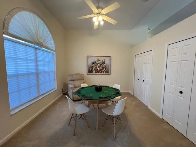 a dining room with furniture and a lamp