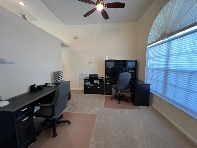 a livingroom with workspace and a window