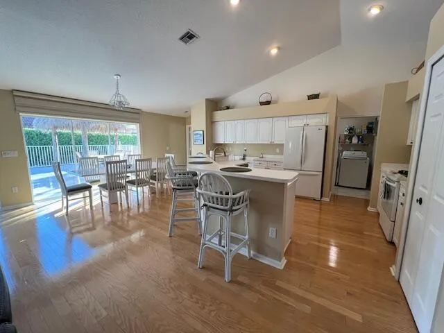 a large kitchen with stainless steel appliances granite countertop a large counter top and a stove
