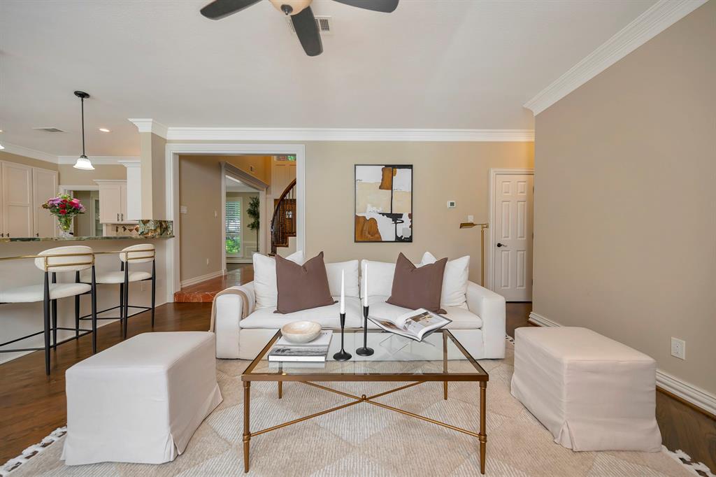 4008 Ramsgate Court Colleyville, TX 76034 - Photo 13 of 33 Open-concept living area featuring wood-finish flooring, crown molding, and a ceiling fan