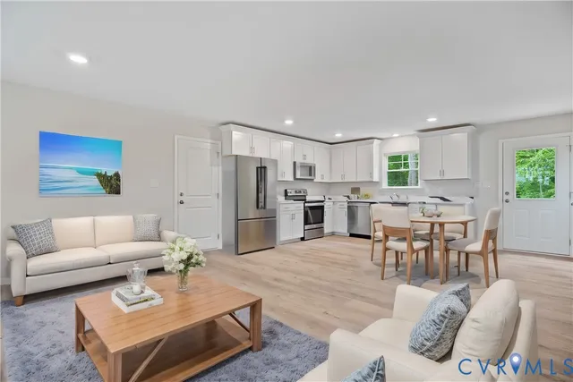 a living room with furniture kitchen and a dining table