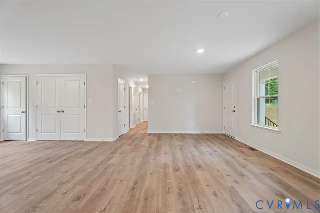 a view of a room with wooden floor and window