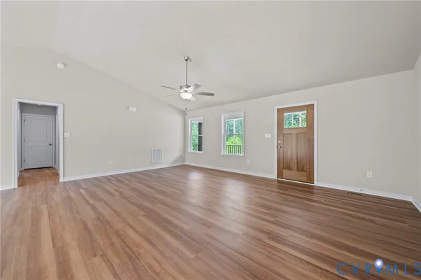 a view of a kitchen with wooden floor and a ceiling fan