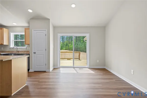 a view of a room with wooden floor and a window