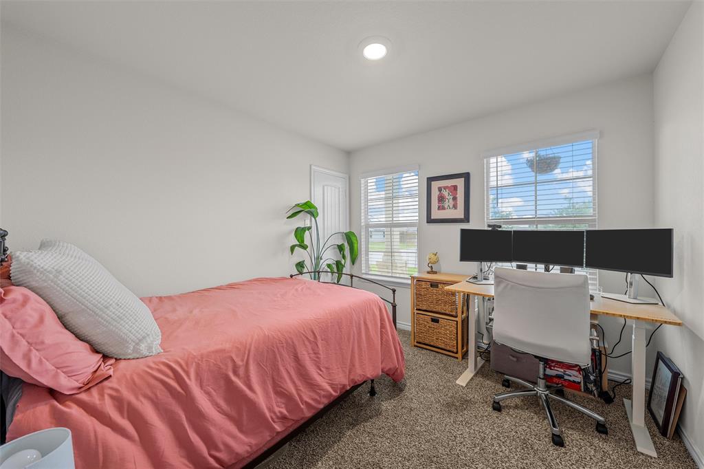 10712 Peperak Court Waco, TX 76708 - Photo 17 of 25 a bedroom with a bed and a desk