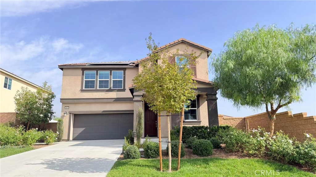 2407 Walker Street Rialto, CA 92377 - Photo 2 of 8 a front view of a house with a garden and plants