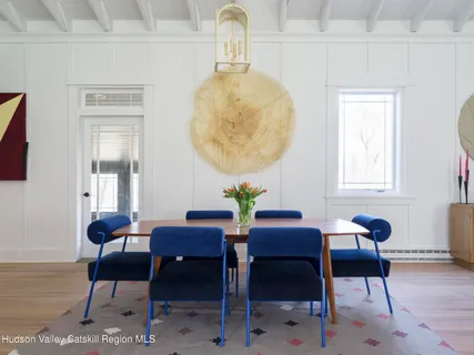 a dining room with furniture and wooden floor