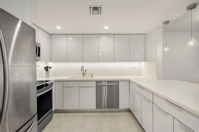 a kitchen with a sink stainless steel appliances and cabinets