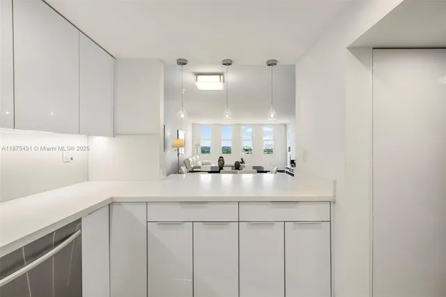a kitchen with kitchen island a sink and a stove top oven