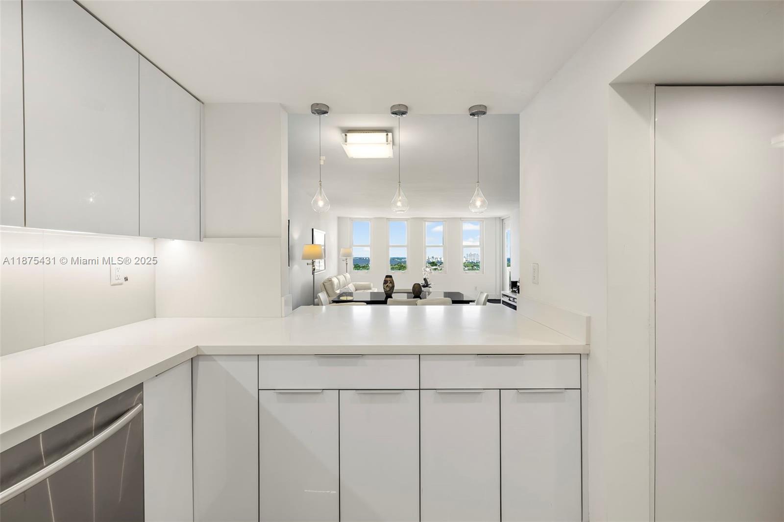 5401 Collins Avenue, Unit 1231 Miami Beach, FL 33140 - Photo 19 of 43 a kitchen with kitchen island a sink and a stove top oven