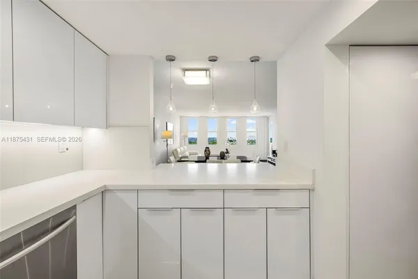 a open kitchen with a stove and white cabinets