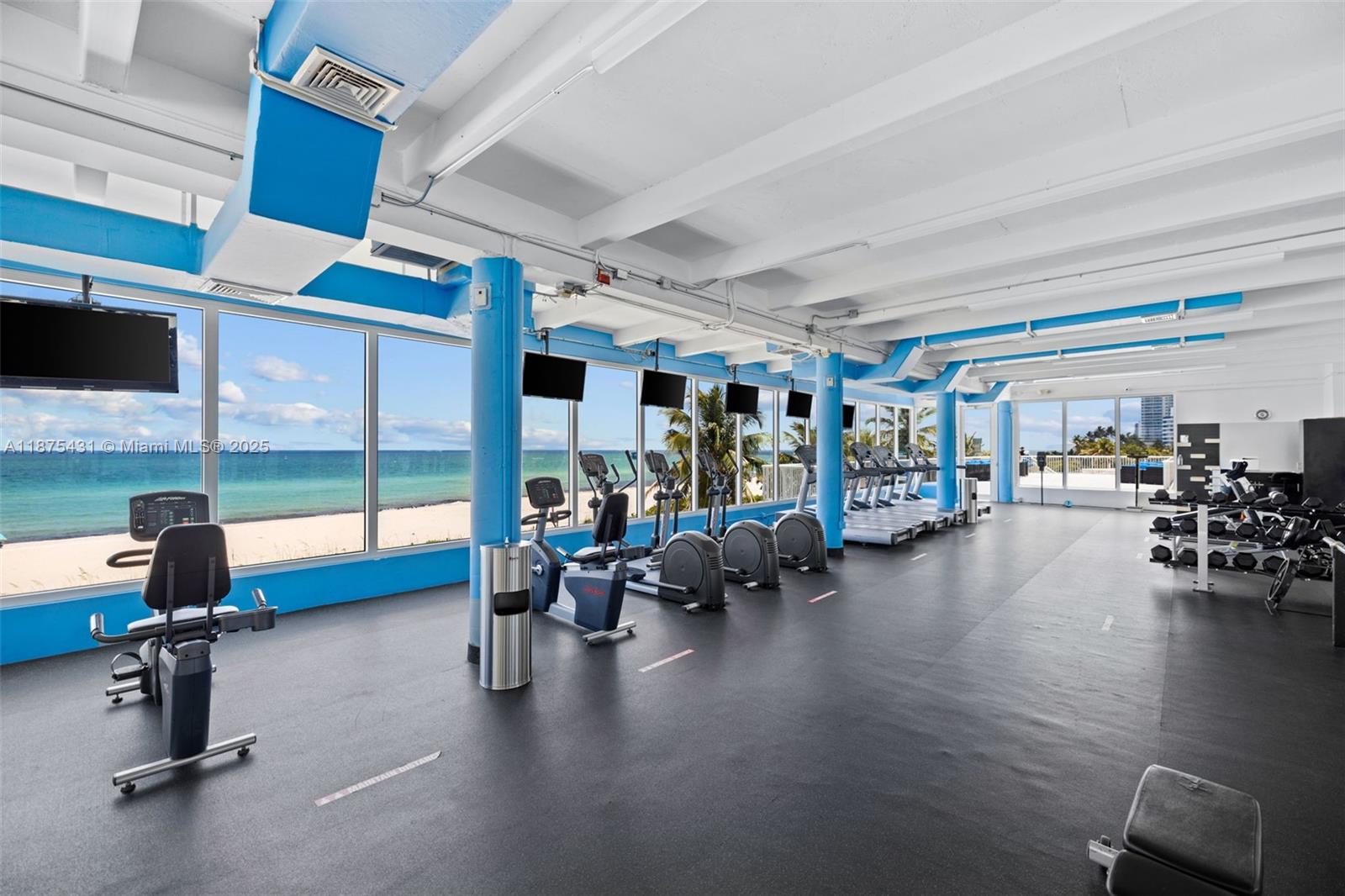 5401 Collins Avenue, Unit 1231 Miami Beach, FL 33140 - Photo 32 of 43 a gym room with lots of gym equipment