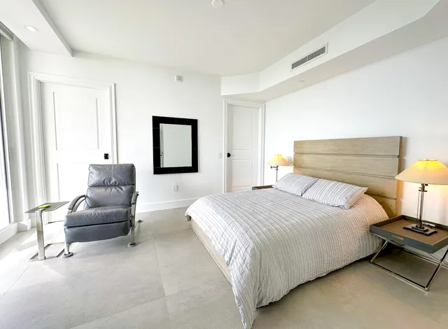 a living room with furniture tv and a large window