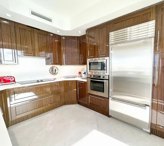 a kitchen with a refrigerator sink and cabinets