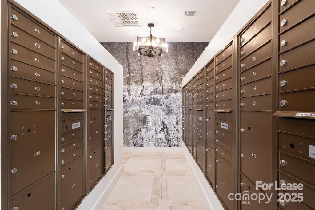 3110 Doe River Way, Unit CHADWICK Matthews, NC 28105 - Photo 13 of 48 a hallway with windows and chandelier