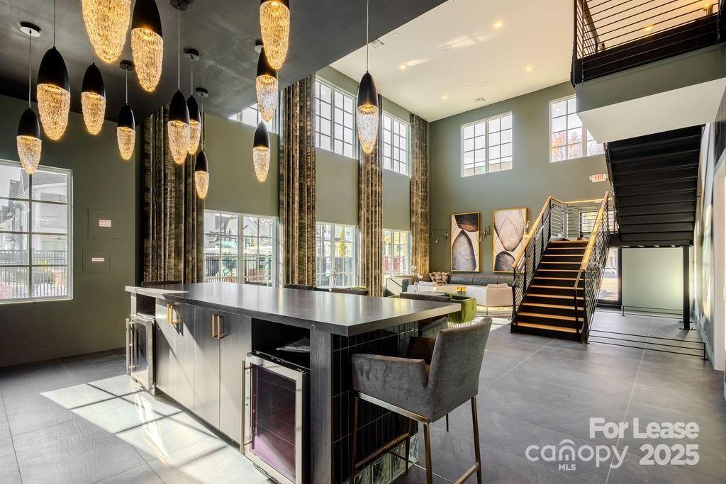 3110 Doe River Way, Unit CHADWICK Matthews, NC 28105 - Photo 22 of 48 a dining hall with stainless steel appliances granite countertop a stove and a view of the kitchen