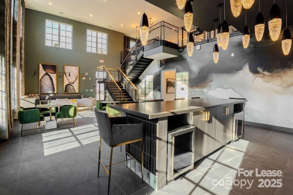 3110 Doe River Way, Unit CHADWICK Matthews, NC 28105 - Photo 25 of 48 a living room with furniture a chandelier and kitchen view