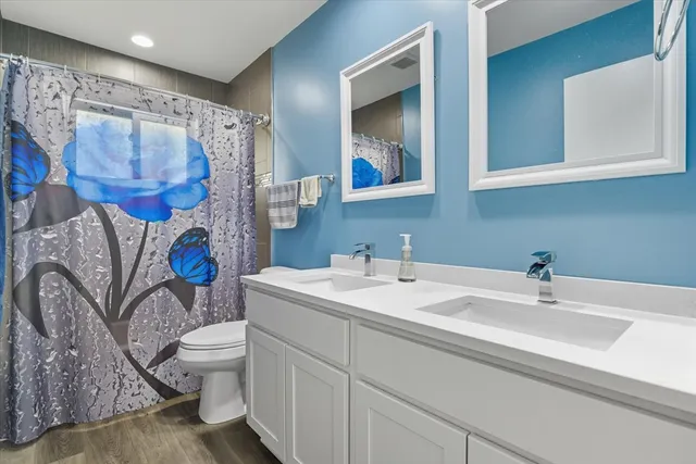 a bathroom with a sink toilet and shower