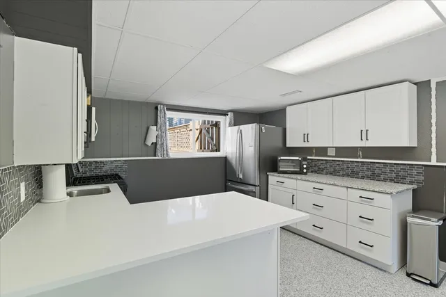 a kitchen with stainless steel appliances a refrigerator sink and cabinets