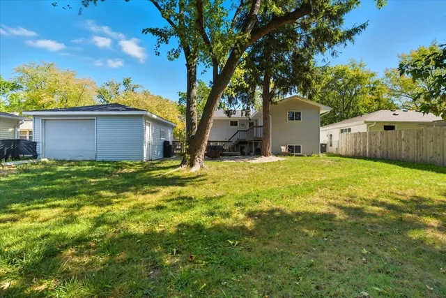 a view of a backyard with large tree