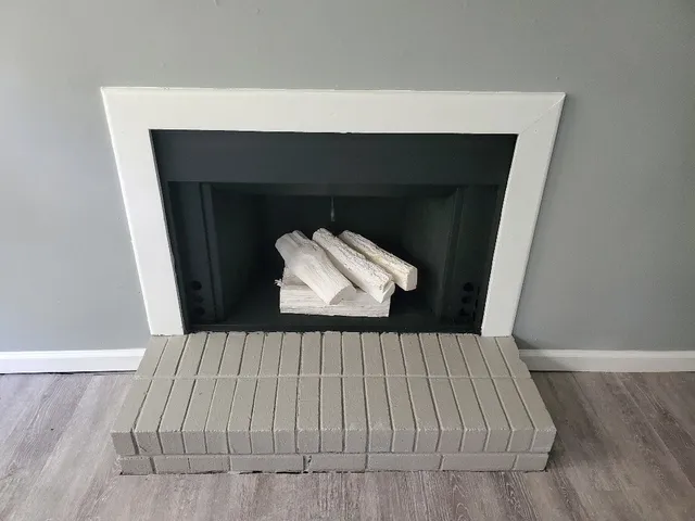 a view of a livingroom with wooden floor and an empty room