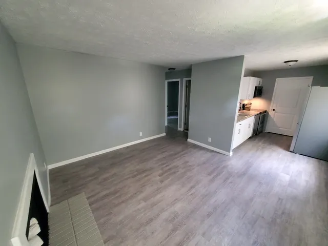 a bathroom with a granite countertop sink mirror vanity and toilet