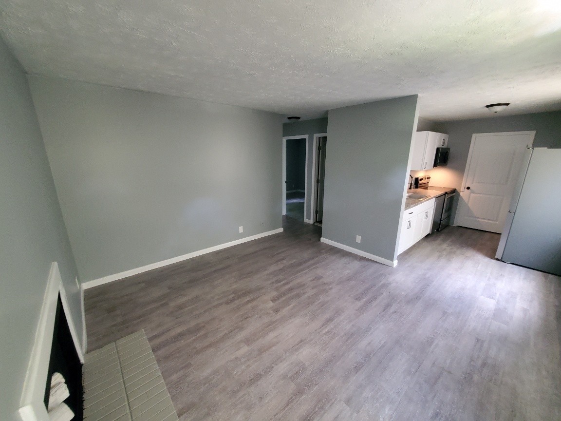 1317 Pierce Road Madison, TN 37115 - Photo 12 of 18 a view of a livingroom with wooden floor and an empty room