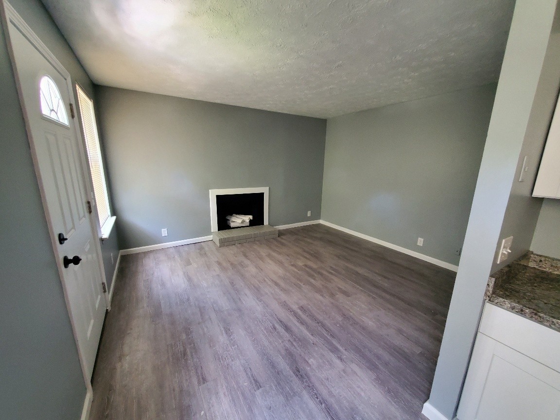 1317 Pierce Road Madison, TN 37115 - Photo 9 of 18 a view of an empty room with wooden floor and a window