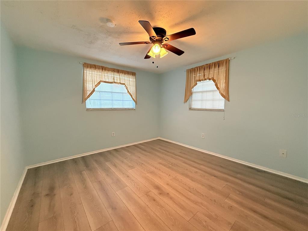 4221 Touchton Place, Unit 4221 New Port Richey, FL 34652 - Photo 13 of 37 wooden floor in an empty room with a window