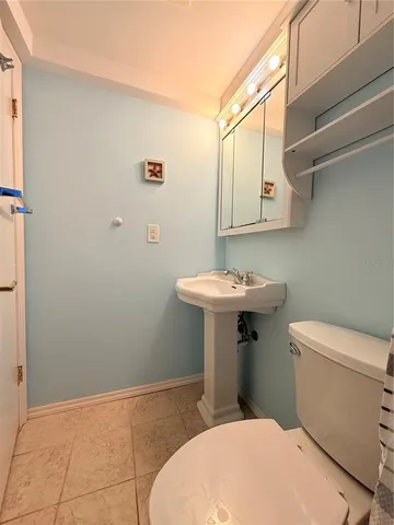 a bathroom with a sink a toilet and mirror