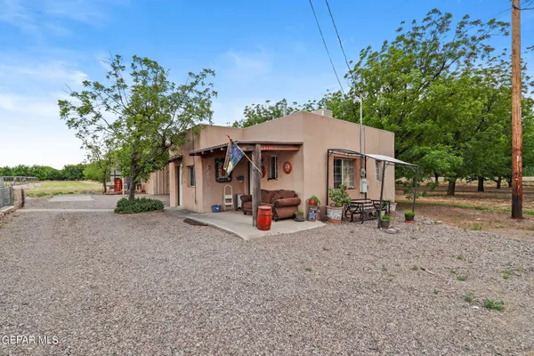 a view of a house with backyard and a tree