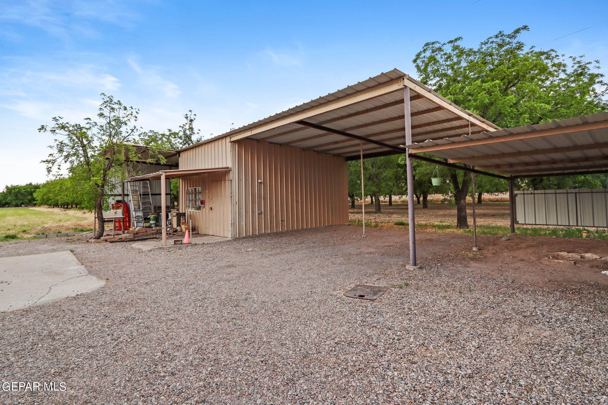 3025-3035 West O'Hara Road Anthony, NM 88021 - Photo 9 of 41 a view of a house with backyard and a barn