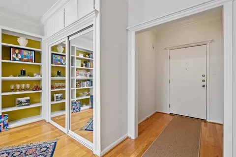 a view of a bedroom with wooden floor